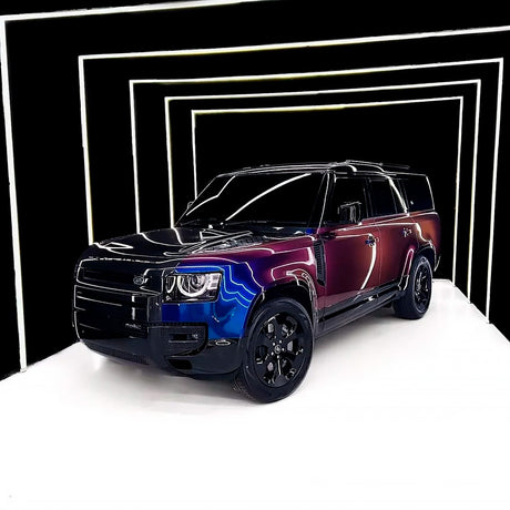 Front-side view of SUV wrapped with TeckWrap Violet Sunrise (RD14-HD) Gloss Vinyl, showcasing dynamic, eye-catching color gradients under bright showroom lighting.