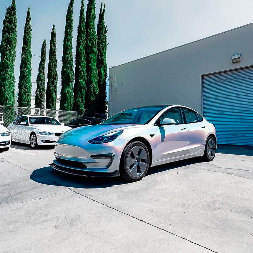 Side angle of a Tesla Model 3 featuring TeckWrap White Fireworks (RCH03-HD) Gloss Vinyl, emphasizing its stunning pearlescent color shift for premium car styling.