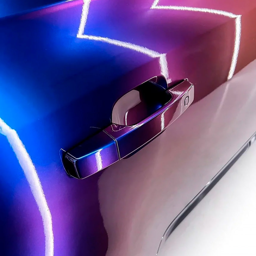 Detailed door handle close-up with TeckWrap Violet Sunrise (RD14-HD) Vinyl Wrap, clearly illustrating glossy reflections and rich color shifts between blue and violet.