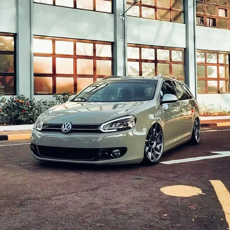 Slammed Volkswagen wagon wrapped in TeckWrap Moss Green CG23-HD Glossy Vinyl, parked roadside with custom stance and vivid color.