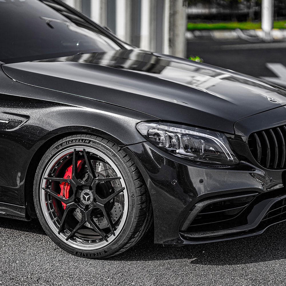 Detailed close-up of car wheel and fender wrapped in TeckWrap Ebony Sparkle CK202-HD gloss vinyl with metallic sparkle effect