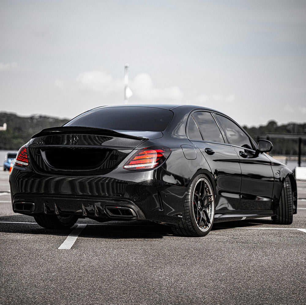 Mercedes-Benz sedan rear side wrapped in TeckWrap CK202-HD Ebony Sparkle gloss vinyl showing reflective black sparkle effect