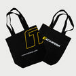 Stylish black TeckWrap canvas tote bags featuring bold yellow and white branding, perfect for carrying tools, accessories, or everyday essentials