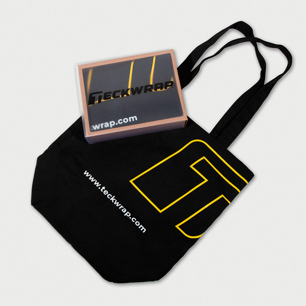 Premium TeckWrap promotional gift set including a black canvas bag with logo and a branded box, showcasing practical and stylish packaging
