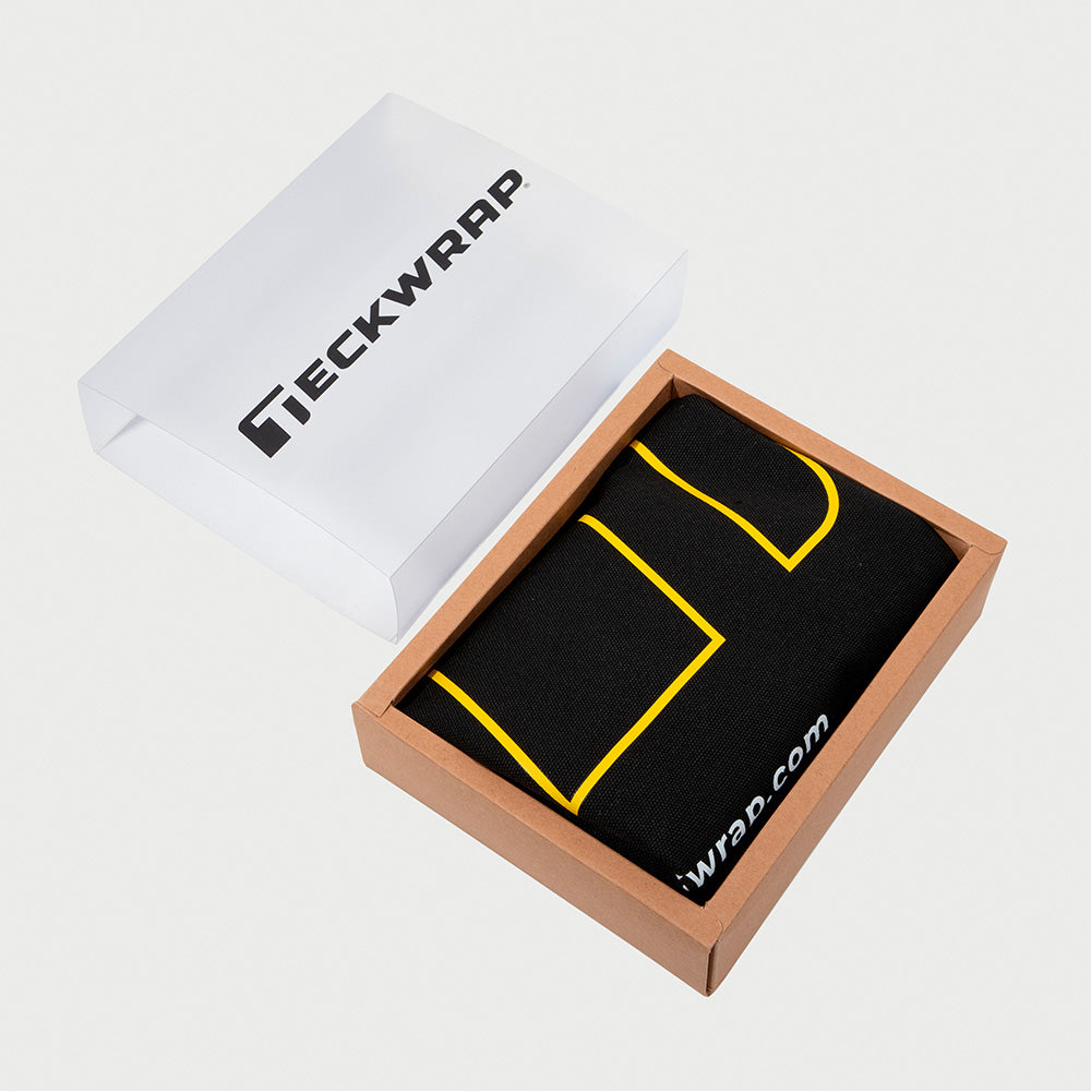 Durable and reusable TeckWrap black canvas bag elegantly packed in a branded brown and white gift box, combining functionality with presentation appeal