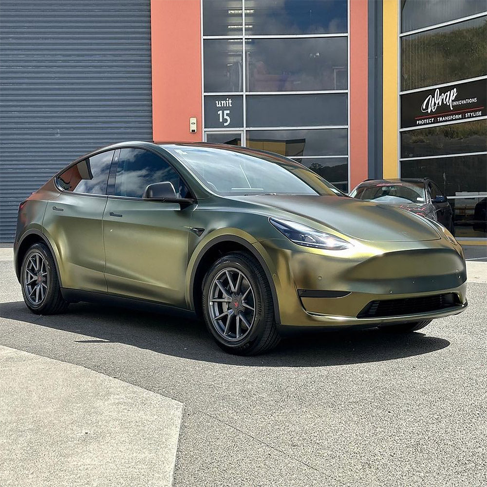 Tesla Model Y wrapped in TeckWrap Greenfinch Gold HM09 satin metallic vinyl parked outside