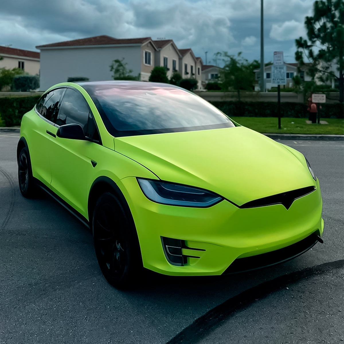Tesla Model X elegantly wrapped in TeckWrap Lawn Green (SMT14) satin vinyl, highlighting its bold, eye-catching color and sleek matte appearance.