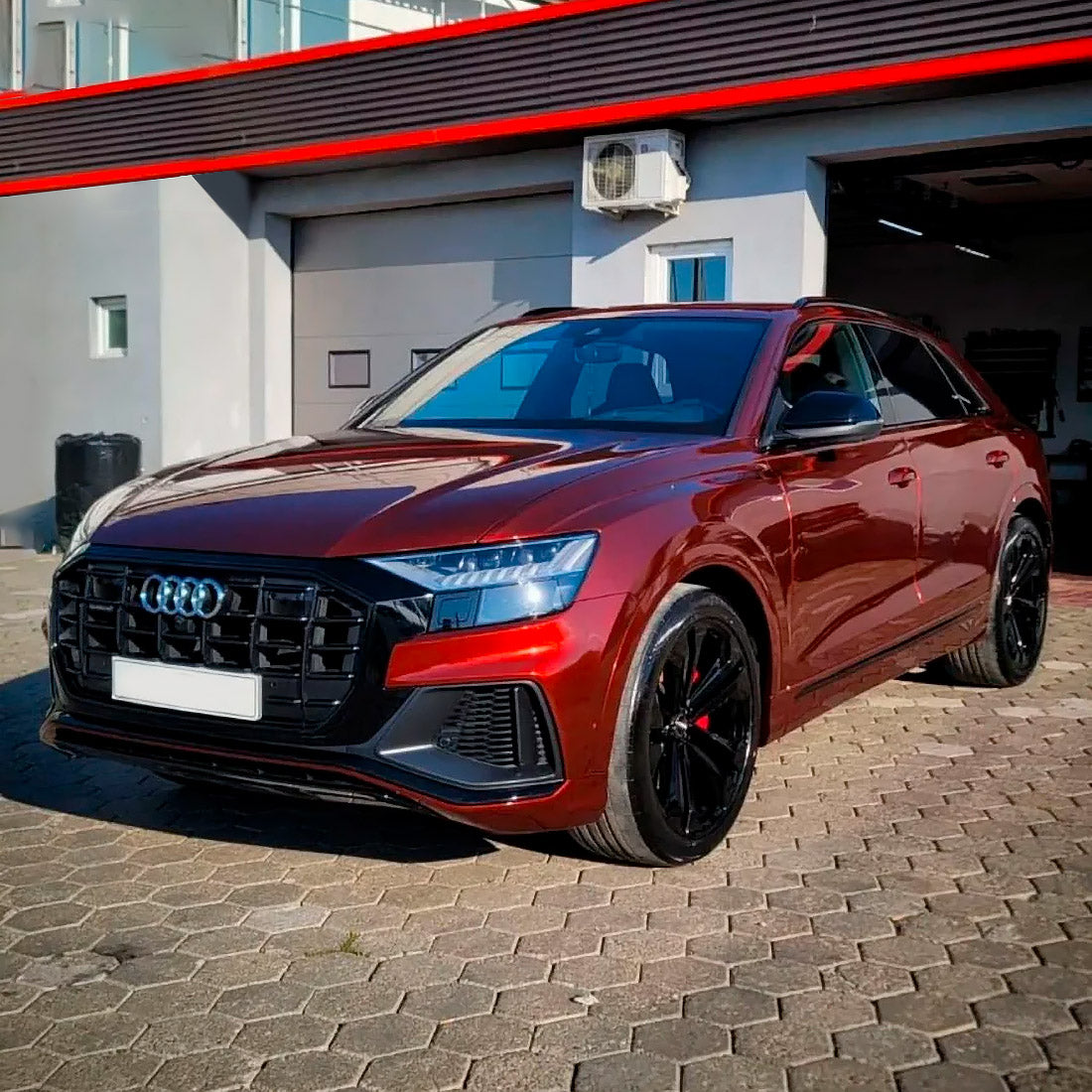 Front-side profile of an Audi Q8 SUV expertly wrapped in TeckWrap Supreme Red Gloss Metallic Vinyl (GAL26-HD), highlighting the wrap’s brilliant reflective metallic sheen, deep glossy red hue, and precision application, giving the vehicle a distinctively elegant and sporty look.