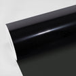 Close-up view of TeckWrap Zenith05 Window Film, showcasing its glossy, deep-black finish on a roll, ideal for superior window tinting and enhanced privacy.