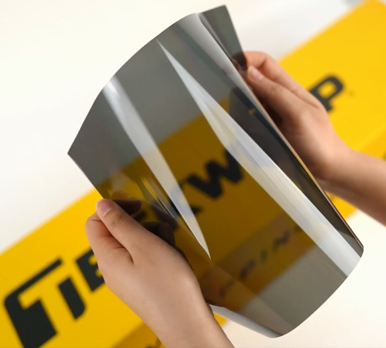 Hands showing sample of C15-2mil Car Window Tint Film