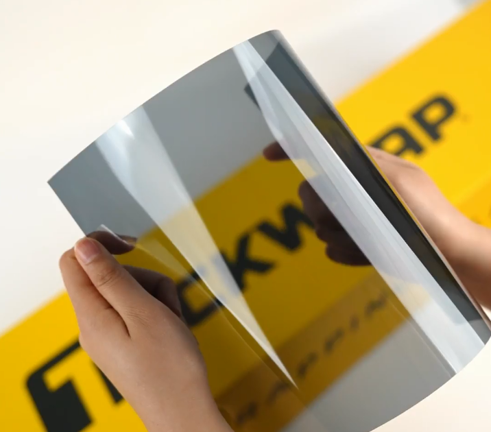 Hands showing sample of C30-4mil Car Window Tint Film by Teckwrap