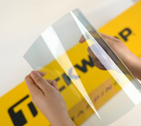 Hands showing sample of C70-4mil Car Window Tint Film by Teckwrap
