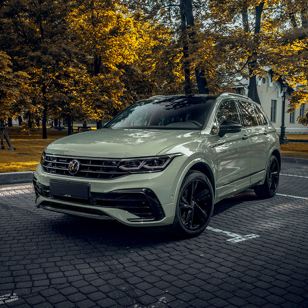 SUV wrapped in TeckWrap Top Coated Moss Green CG23-SH gloss vinyl parked on a cobbled street
