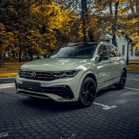 SUV wrapped in TeckWrap Top Coated Moss Green CG23-SH gloss vinyl parked on a cobbled street