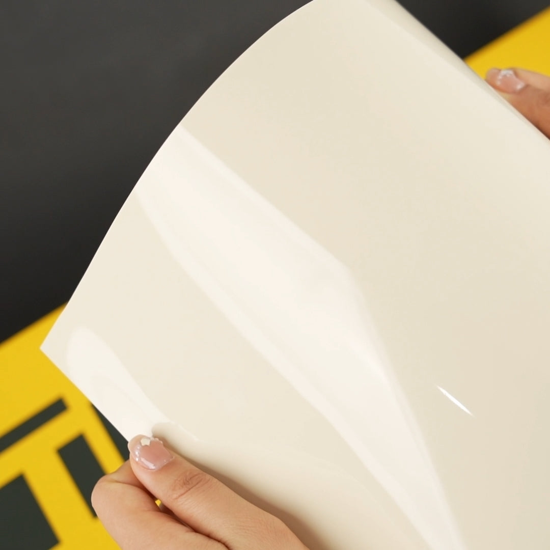 Close-up view of Ivory Cream (CG26-HD) Gloss Vinyl Wrap by TeckWrap, highlighting its glossy sheen and elegant creamy hue.