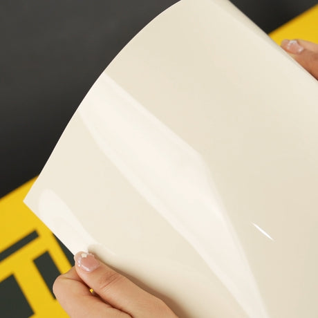 Close-up view of Ivory Cream (CG26-HD) Gloss Vinyl Wrap by TeckWrap, highlighting its glossy sheen and elegant creamy hue.