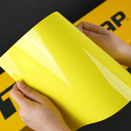 Hands displaying the glossy finish of TeckWrap Grape Green (CG42-HD) Vinyl Wrap against TeckWrap branded background
