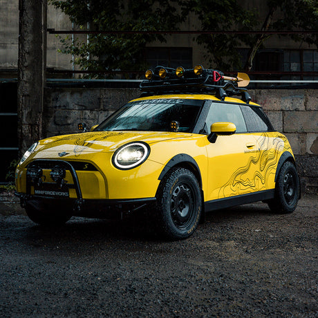 Mini Cooper wrapped in TeckWrap Sunray Yellow gloss vinyl, featuring off-road modifications for an adventurous look.