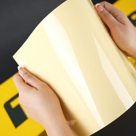 Hands displaying Teckwrap Gloss Amberwave (CG45-HD) Vinyl Wrap sheet, highlighting its glossy, vibrant amberwave color.