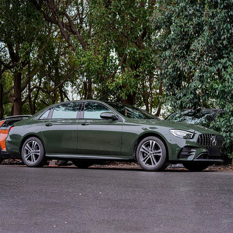 Camouflage Green (CG51-HD) gloss vinyl wrap applied to a Mercedes-Benz car, highlighting the rich green color and sleek finish, demonstrating its use in high-end vehicle customization.