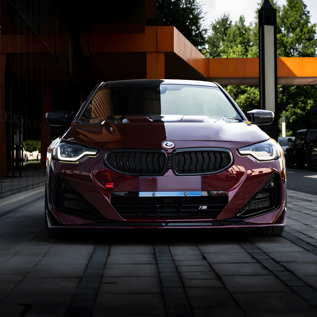 Front view of glossy dark red vinyl wrap BMW