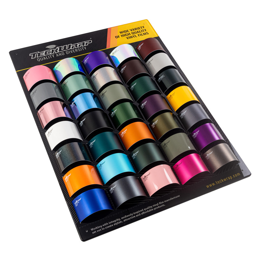 TeckWrap vinyl swatch panel highlighting a range of sophisticated cool-tone wraps, featuring metallic blues, greens, purples, and neutral hues.