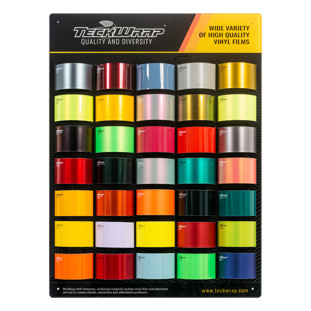 Front-view of TeckWrap Display Set's warm-tone swatch panel with diverse high-gloss and metallic vinyl wraps ranging from bright reds and yellows to deep greens.