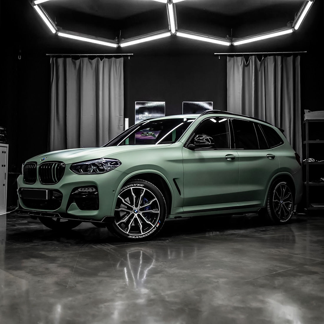 Luxury SUV wrapped in TeckWrap Matte Lizard Grey (SCM23-R) vinyl, displaying an elegant, sporty look under studio lighting.