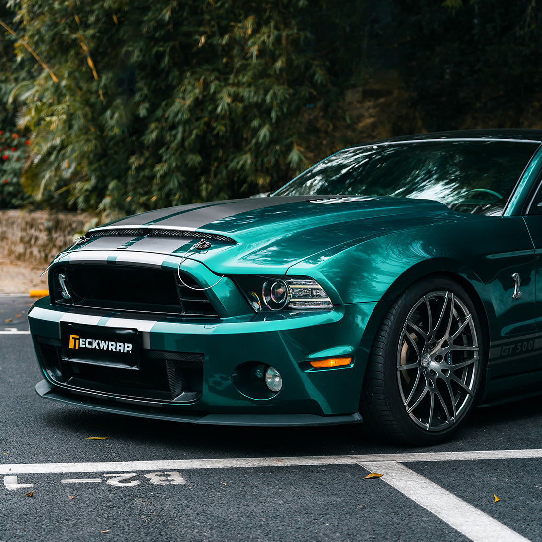 Front angle view of Mustang GT500 in glossy teal Azure Flame vinyl wrap by TeckWrap