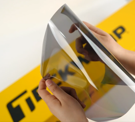 Hands showing sample of M30-2mil Car Window Tint Film by Teckwrap