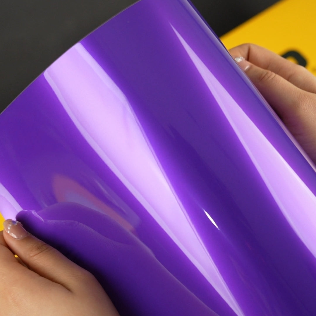 Hands holding TeckWrap A4 Samples of RB20-HD Midnight Purple Vinyl Car Wrap