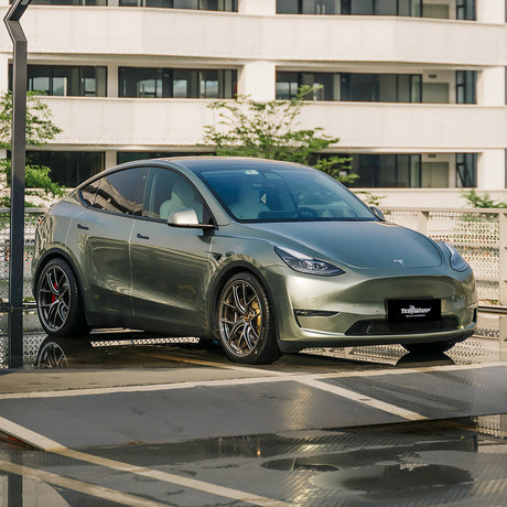 Front side view of Tesla Model Y featuring TeckWrap Wilderness Green RB35-HD gloss vinyl