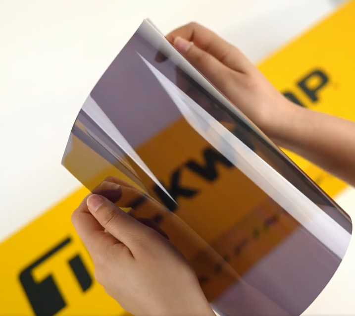 Hands showing sample of SC15-3mil Car Window Tint Film by Teckwrap