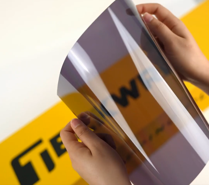 Hands showing sample of SC30-3mil Car Window Tint Film by Teckwrap