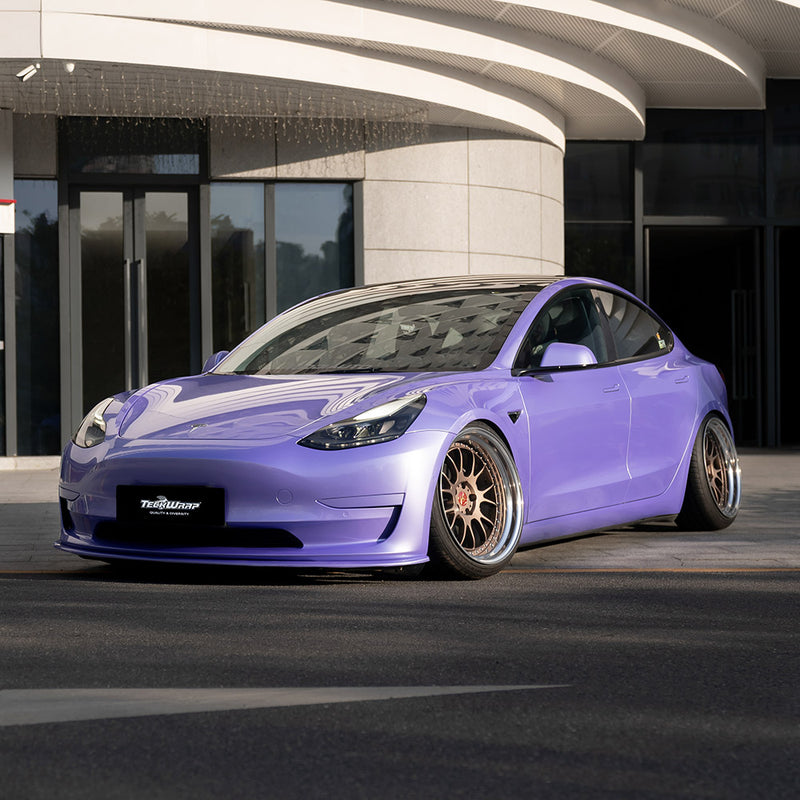 Tesla Model 3 customized with TeckWrap SL07-HD Royal Purple gloss wrap, featuring a bold and reflective finish under sunlight.