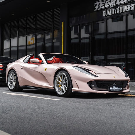Ferrari wrapped in TeckWrap Strawberry Milk CG50-HD vinyl wrap in gloss finish parked on city street