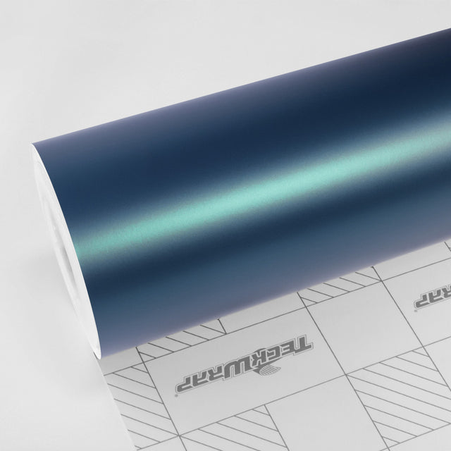 TeckWrap Jewel Green (SMT16) Satin Metallic vinyl wrap roll showcasing its teal-blue gradient sheen on white backing paper.