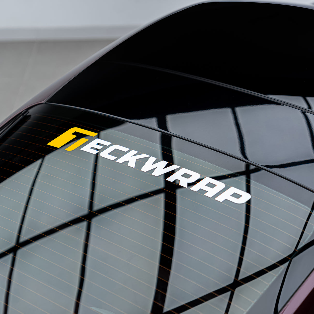 Final result of TeckWrap logo sticker cleanly applied to car rear windshield