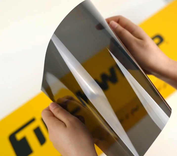Hands showing sample of W15-3.5Mil Car Window Tint Film by Teckwrap