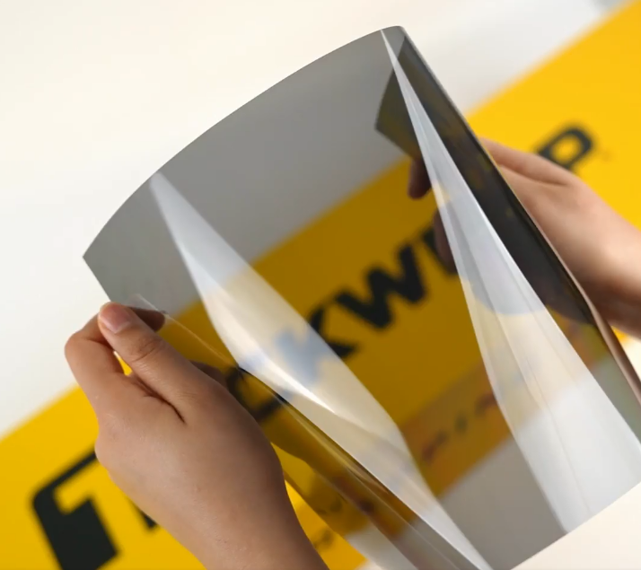 Hands showing sample of W30-3.5Mil Car Window Tint Film by Teckwrap