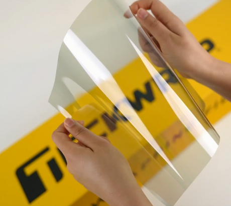Hands showing sample of W70S-4mil Car Window Tint Film by Teckwrap