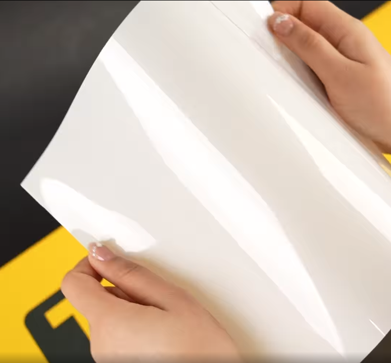 Hands showing A4 Sample of X85 Essential TeckWrap Paint Protection Film