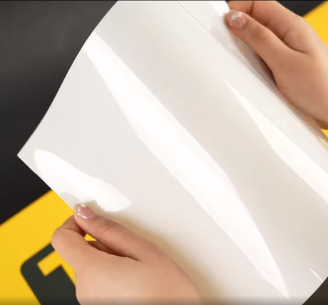 Hands showing A4 Sample of X85 Essential TeckWrap Paint Protection Film