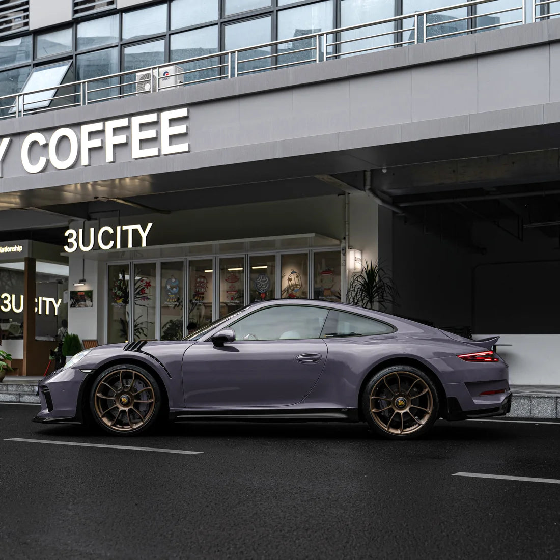 Porsche with a High Gloss Dusky Grape Vinyl Wrap finish.