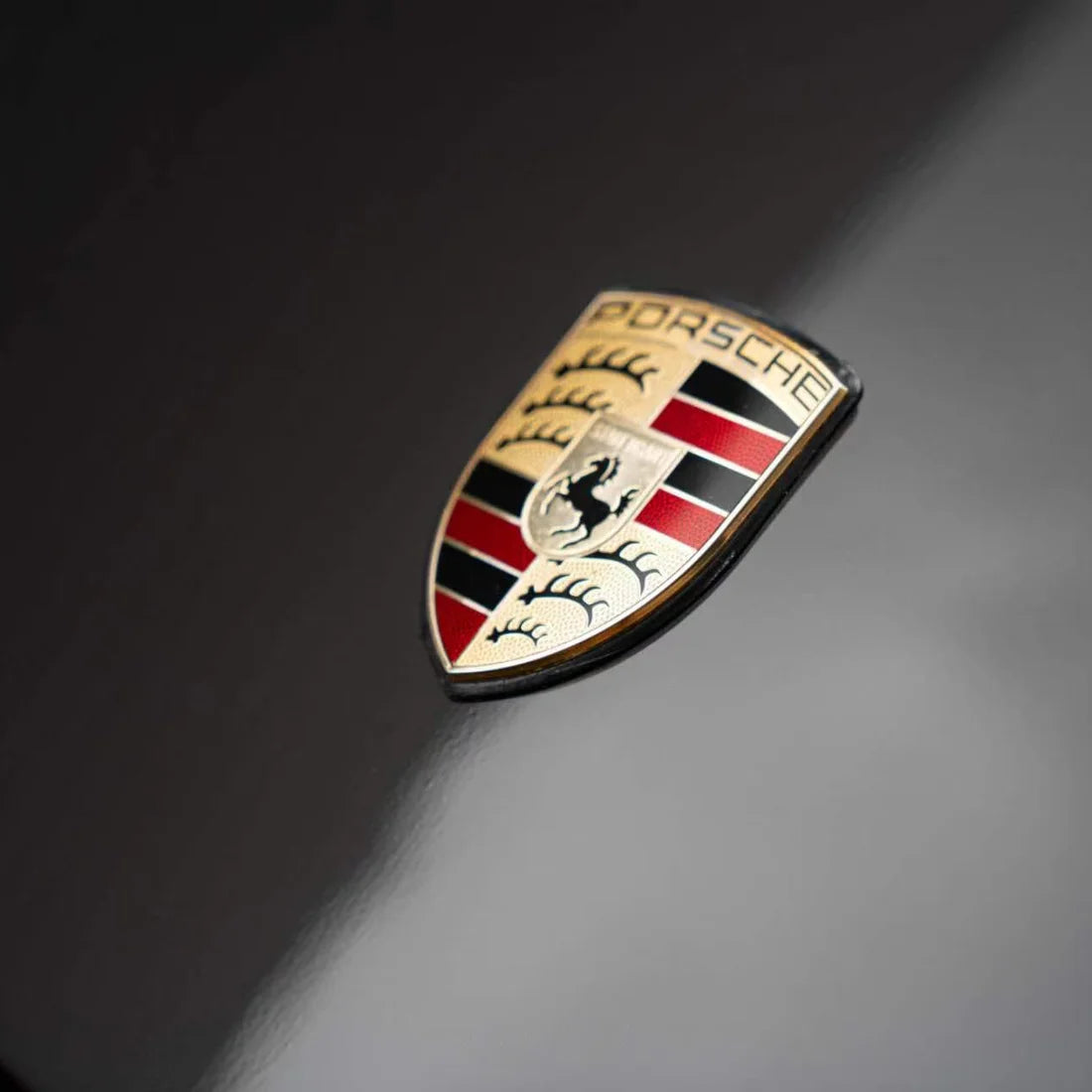 Porsche logo with Stone Bronze Gloss Metallic PPF