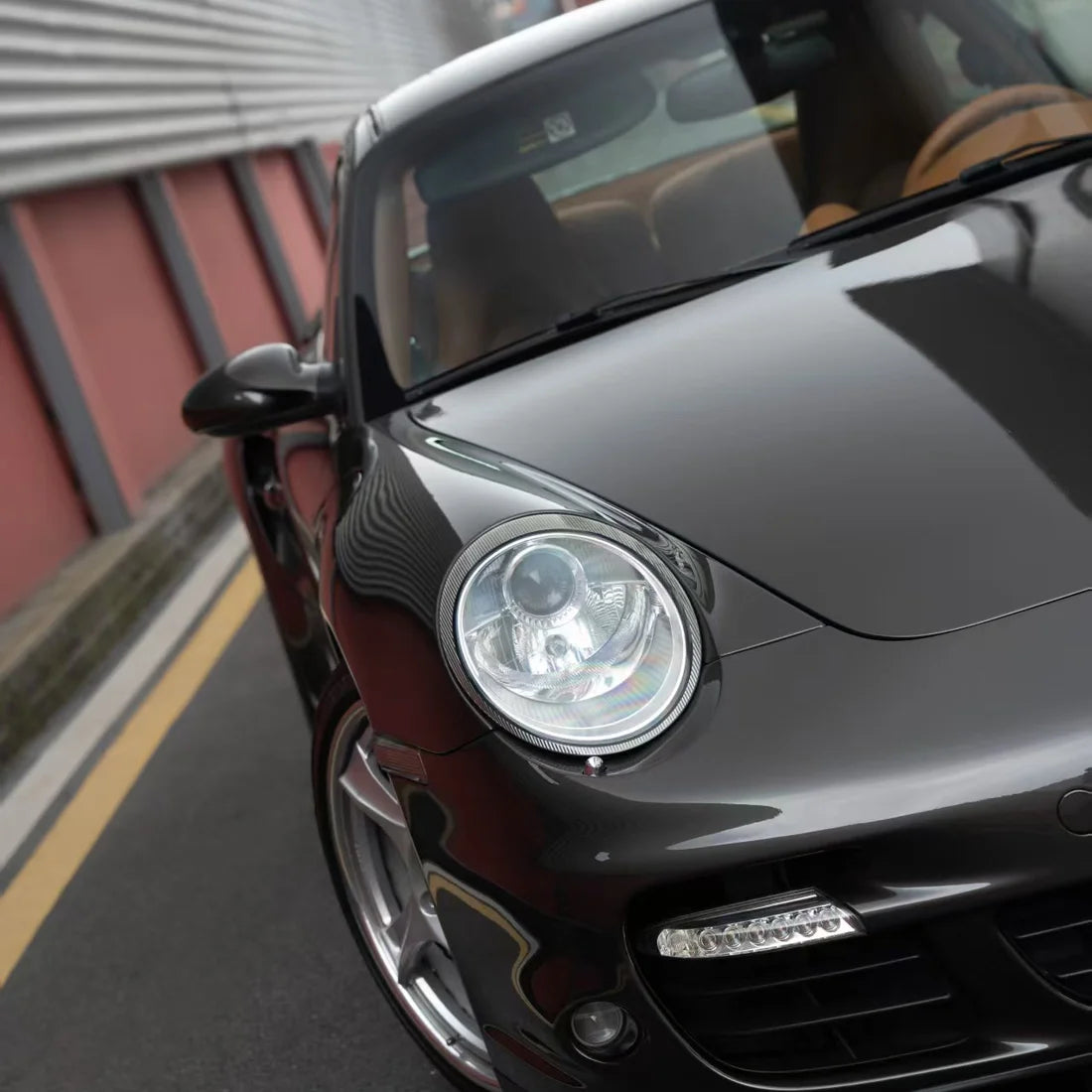 Front view of Porsche wrapped in Stone Bronze Gloss Metallic PPF