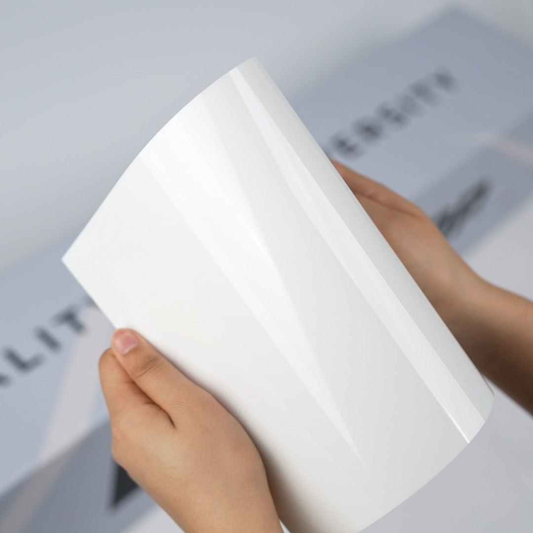 Gloss white TeckWrap A5 Pure Color Paint Protection Film sample held in hands