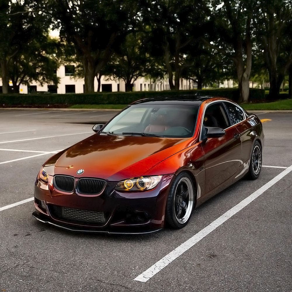 BMW wrapped in TeckWrap Madeira Red (RD17-HD) Chameleon Metallic Vinyl, demonstrating the luxurious and bold metallic color transition from deep purple-red to striking metallic copper-red outdoors.