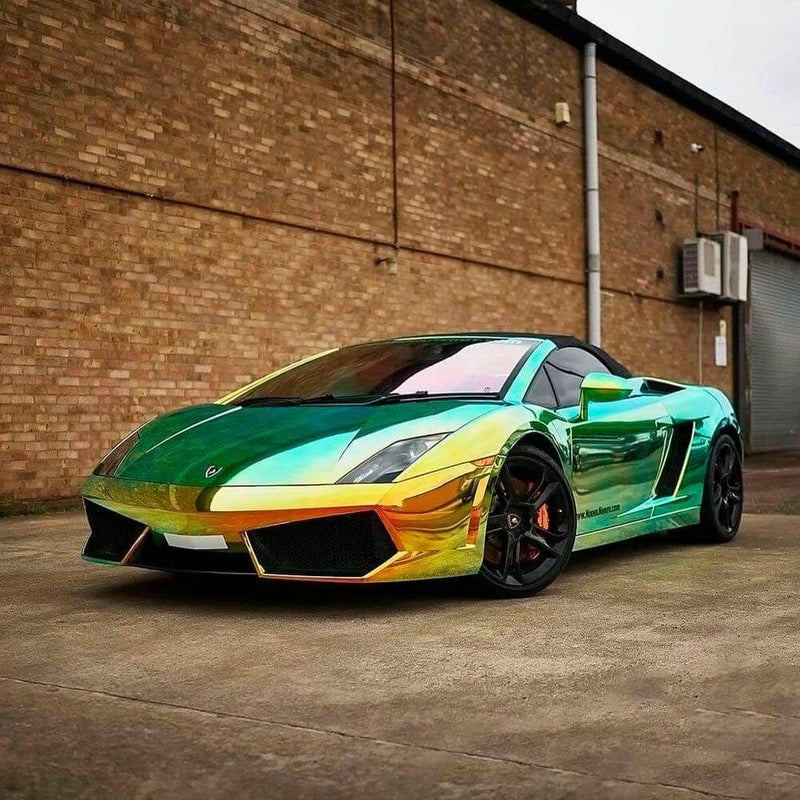 Lamborghini wrapped in TeckWrap MCH02 Ammolite Gem chrome vinyl showcasing bright gold-green color under daylight