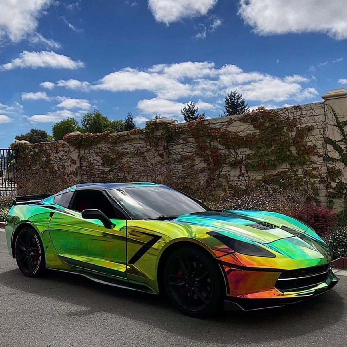 Corvette wrapped in TeckWrap Chrome Ammolite Gem (MCH02) vinyl with ultra-reflective green, yellow, and aqua hues